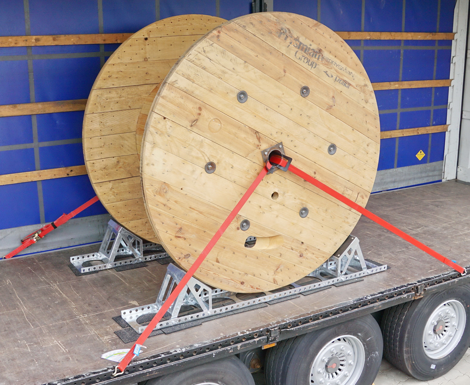 Kabeltrommel auf einem Lkw mit verstellbarer Kabeltrommelsicherung und Zurrgurten gesichert
